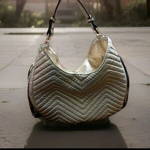 Women's gold metallic hobo style bag with black/gold fringe and gold-tone stars